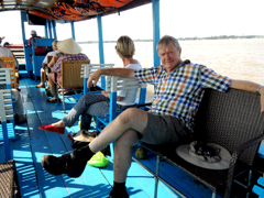 Relax on boat while cruising along Mekong river